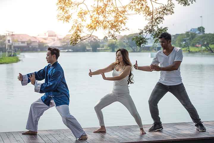 A group of young people practising Qigong