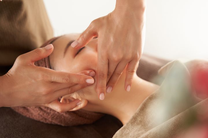 Japanese woman receiving facial massage 