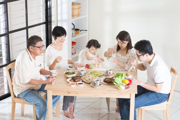 Family of 5 dining at table together