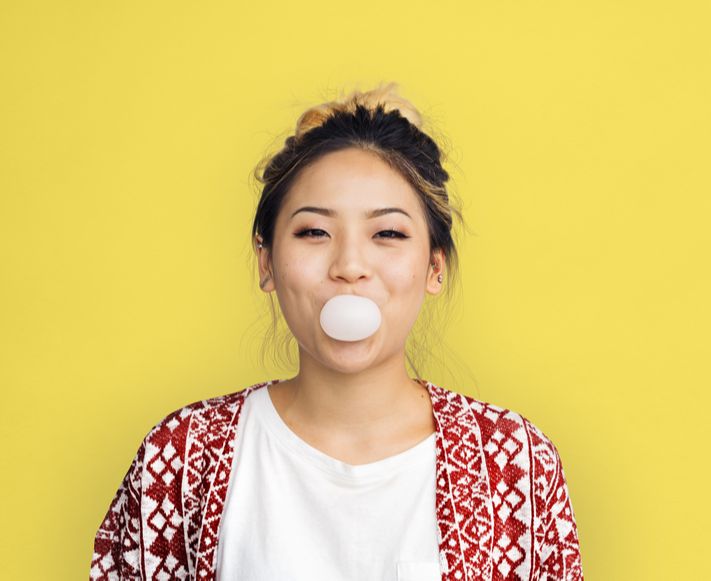Woman blowing a chewing gum bubble