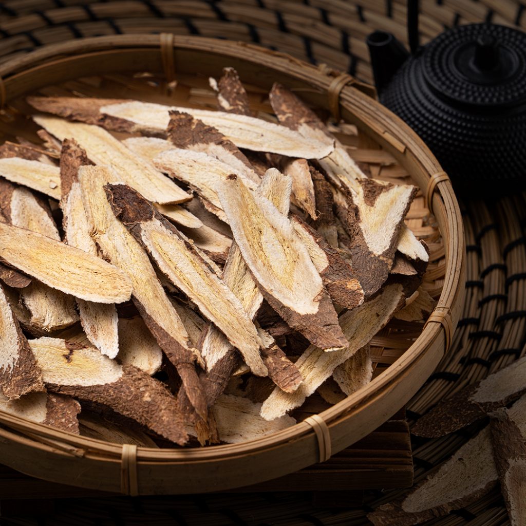 Close up of astragalus root, with a black teapot, Milkvetch Root, Huang qi 黄芪