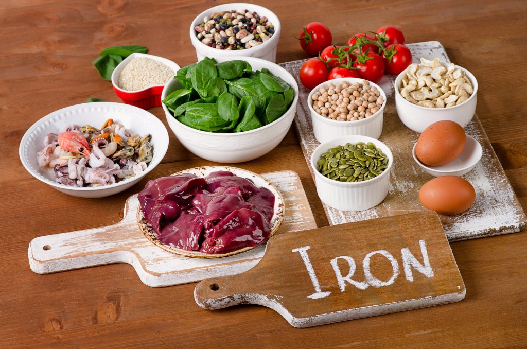Vegan diet foods high in iron, including eggs, nuts, spinach, beans, seafood, liver, sesame, chickpeas, tomatoes