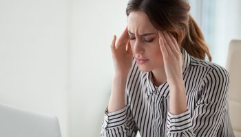 Migraine symptoms may include a headache, vision problems, and dizziness.